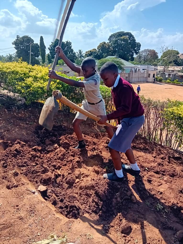 Students digging a new garden bed
